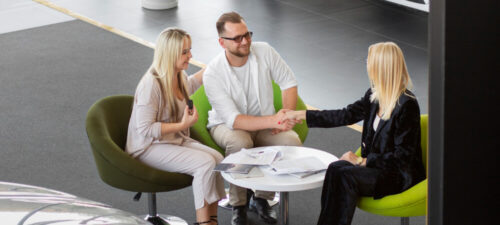 Happy customers in car dealership